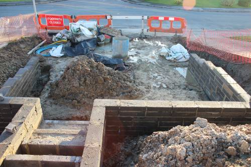 The block retaining wall creates a space for 2 cars