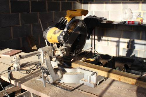 A makeshift bench in the living room and plenty of sawdust