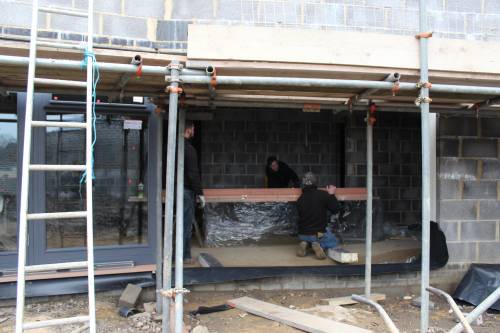 Preparations for lifting the other front windows and french doors into place