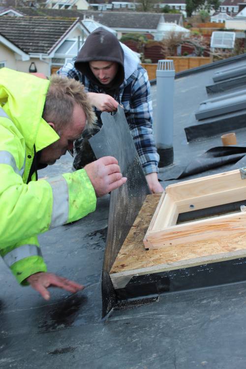 Carefully applying the rubber membrane.
