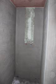Shower cubicle with hot and cold water supply pipes