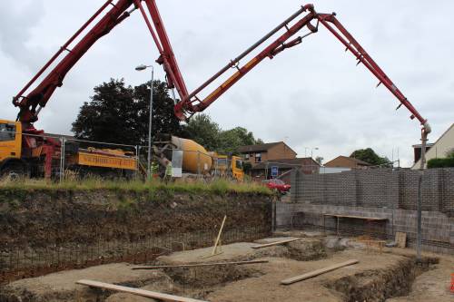 Concrete pump reaching out across the site