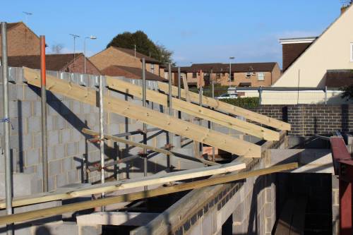 The first trusses go into place on the first day's work